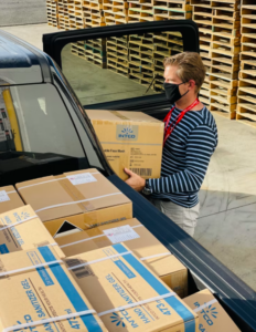 A UGA staff member receives chemicals in a box.